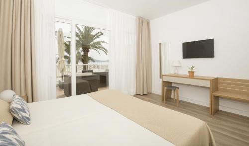 a hotel room with a bed and a desk at Cabot Romantic- Adults Only in Port de Pollensa