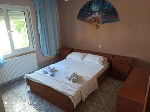 a bedroom with a bed with two towels on it at Big family house (detached) in Néa Péramos