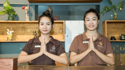 two women sitting at a table with their hands in front at Monsoon Bassac Hotel in Phnom Penh