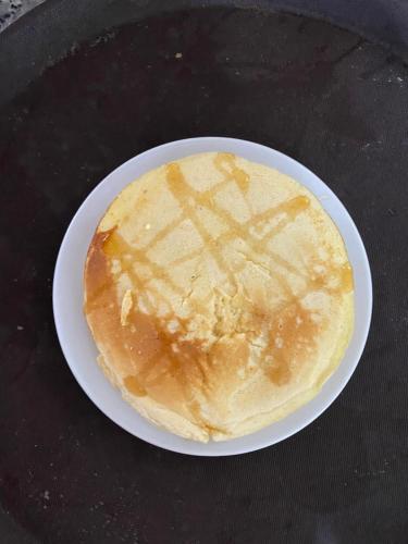 a pancake sitting on a plate on a table at D&D riverside Homestay in Xuân Sơn