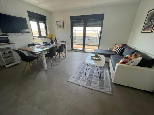 a living room with a couch and a table at Apartman Mara Vodice in Vodice
