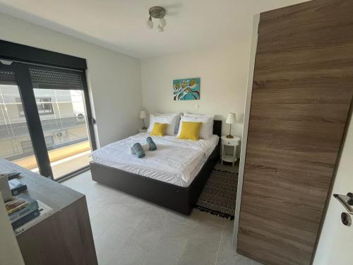 a bedroom with a bed with yellow pillows at Apartman Mara Vodice in Vodice