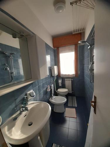 een badkamer met 2 wastafels en 2 toiletten bij Casa La Stazione in Cesenatico