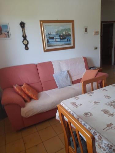 a living room with a couch and a table at Casa La Stazione in Cesenatico