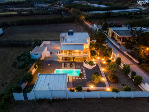 an aerial view of a house with a swimming pool at Aelia Villa in Finikas