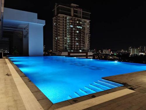 a large swimming pool on top of a building at night at The Grand SS15 2BRs Infinity Pool 100Mbps WiFi in Subang Jaya