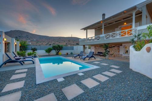 a house with a swimming pool in a yard at Aelia Villa in Finikas
