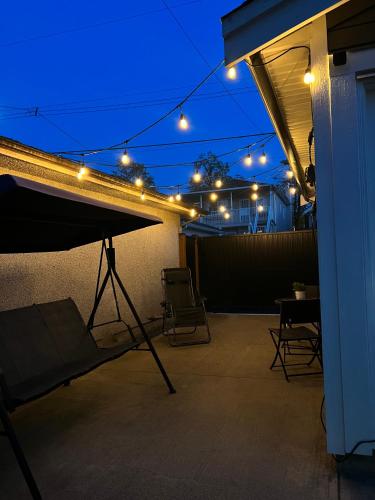 a patio with a table and chairs at night at Family-Friendly, 3 Bed House - Private Backyard-Central Location in Vancouver