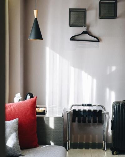 a living room with a red pillow and a window at GOGO Hotel 逢甲館 in Taichung