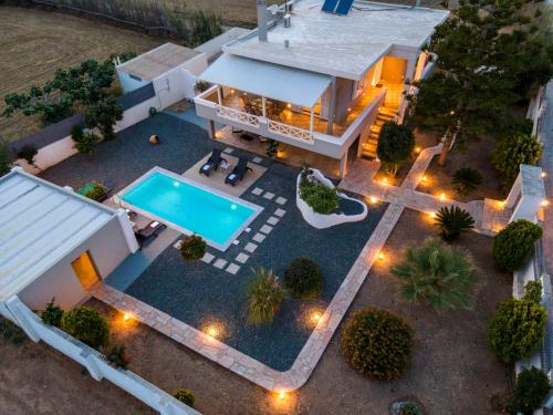 an aerial view of a house with a swimming pool at Aelia Villa in Finikas