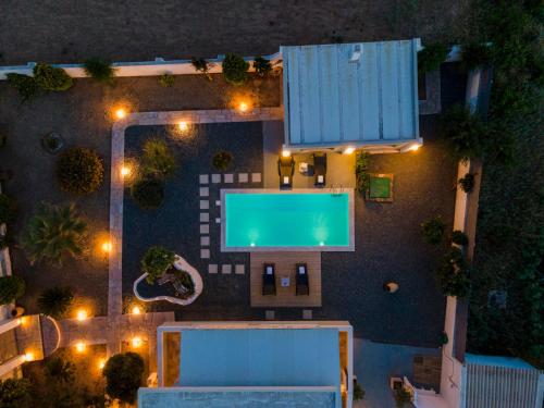 an overhead view of a swimming pool at night at Aelia Villa in Finikas