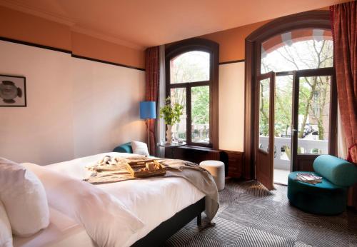 a hotel room with a bed and a window at Jan Luyken Amsterdam in Amsterdam
