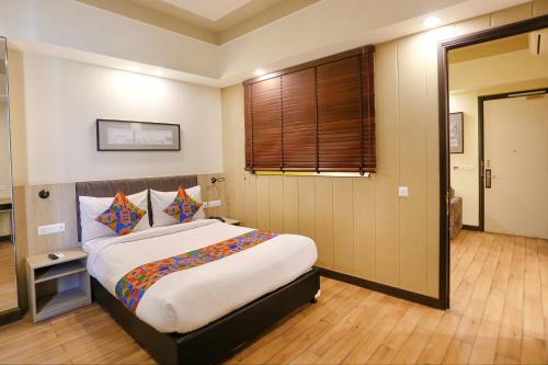 ein Schlafzimmer mit einem großen Bett in einem Zimmer in der Unterkunft FabHotel Sapphire 83 in Gurgaon