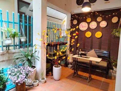 a kitchen with a sink and a table and some plants at Cheriladyhomestayhue in Hue