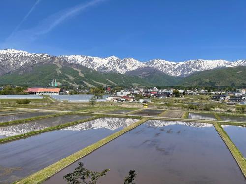 a view of a town with mountains in the background at Hotel Sejour Mint in Hakuba in Hakuba