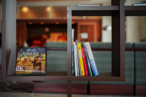 a group of books sitting on a shelf at Yuyado Unzen Shinyu in Unzen