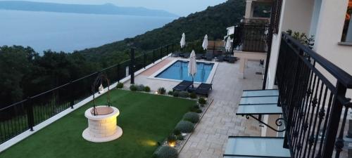 a balcony with a view of a swimming pool at Apartments Villa Elma in Mošćenička Draga