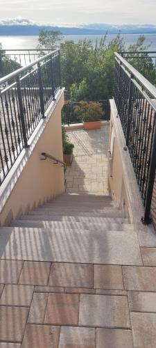 a set of stairs with a view of the ocean at Apartments Villa Elma in Mošćenička Draga