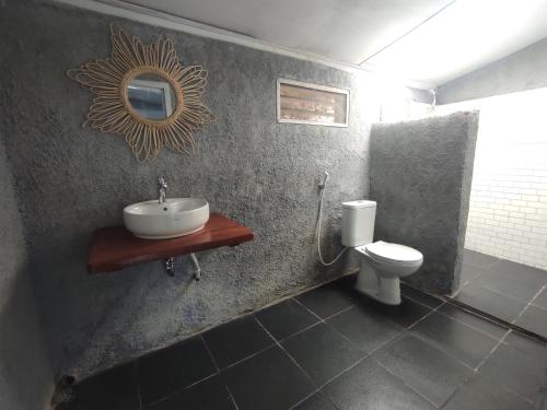 a bathroom with a sink and a toilet at Hub Tata Guesthouse in Tuk Tuk