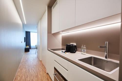 a kitchen with a sink and a counter top at Résidence du Lys - Perrin Apartments in Luxembourg