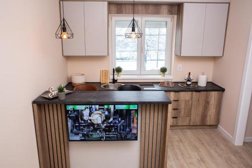 a kitchen with a tv on a counter at Galaxy Apartments in Belgrade