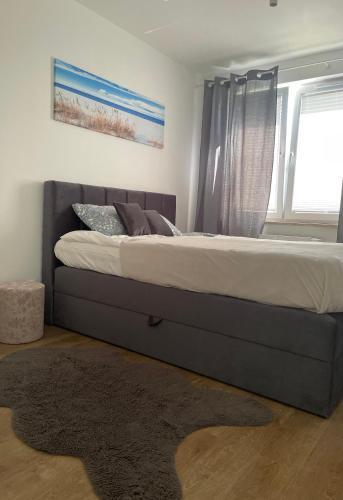 a large bed in a bedroom with a window at Apartament Wiczlino Tęczowa in Gdynia