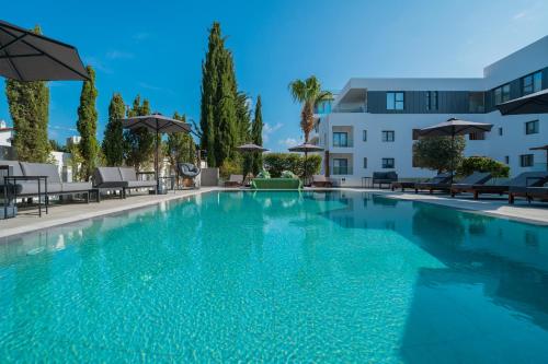 a large swimming pool in front of a building at Silver Park by Deserve in Paphos