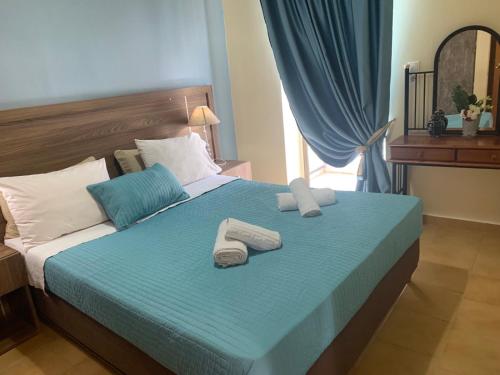a bedroom with a bed with two towels on it at Irini Kalyves II in Kalyves
