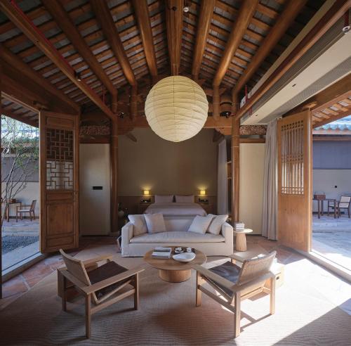 a living room with a couch and a table at Jiangnan House Chaozhou in Chaozhou
