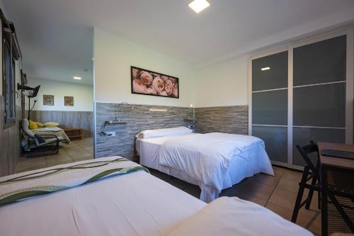 a hotel room with two beds and a chair at Gorosarri in Escoriaza