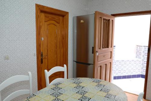a dining room with a table and a refrigerator at Chalet Completo Luna de Carboneras in Carboneras