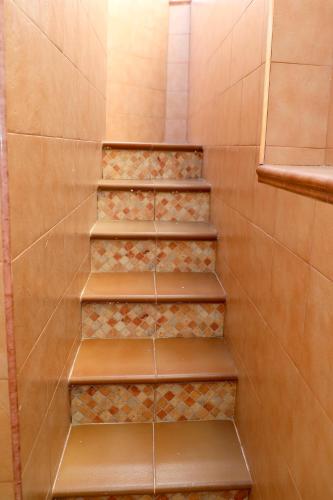 a staircase in a bathroom with brown tiles at Chalet Completo Luna de Carboneras in Carboneras
