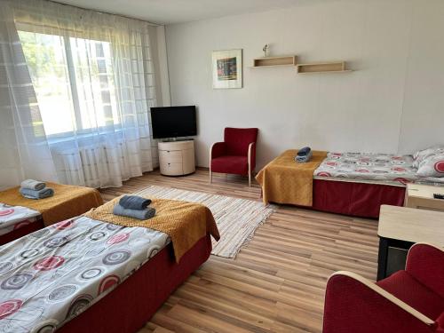 a hotel room with two beds and a television at Kallaste Hostel in Kallaste