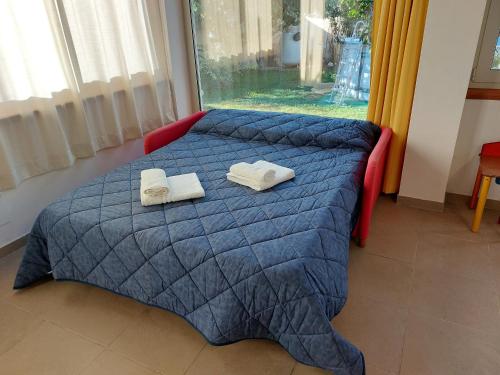 a bedroom with a bed with two towels on it at Dimora allo stagnone in Marsala