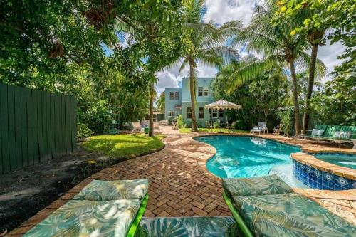 a swimming pool in front of a house at Welcome to Casa Kanuga, The Secret Gem of WPB! in West Palm Beach