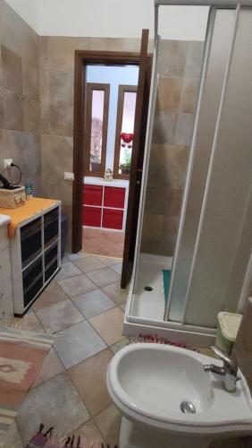 a bathroom with a shower and a toilet and a sink at Paraiso Sardo 1 in Villasimius