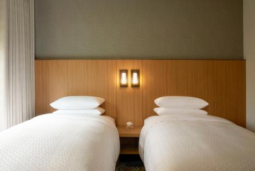 two beds sitting next to each other in a room at Four Points by Sheraton Seoul, Guro in Seoul