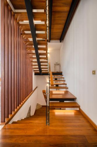 a staircase in a building with wooden floors and wooden beams at Beacon By The Bay Villas and Suites by the Clarks in Matara