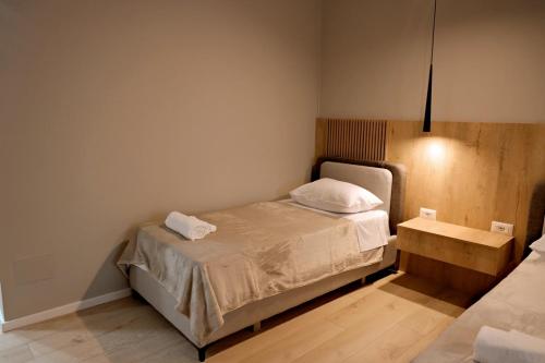 a small bedroom with a bed and a table at Sol Hotel in Shkodër