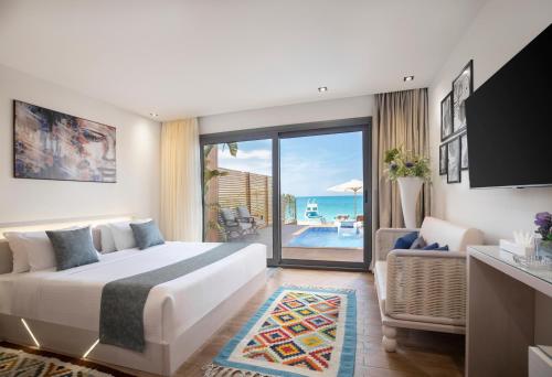 a hotel room with a bed and a view of the ocean at X Eastern Sidi Abdel Rahman Resort & Spa in El Alamein
