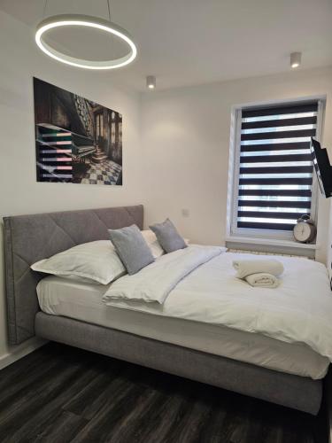1 cama grande en un dormitorio con ventana grande en Galaxy Apartments 2 en Słupsk