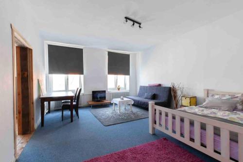 a bedroom with a bed and a living room with a desk at City Apartment in Lübeck