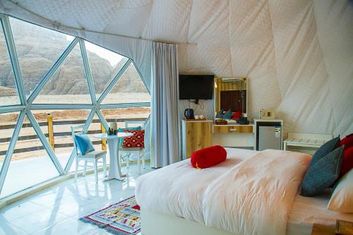 Desert Season Camp في وادي رم: غرفة نوم بسرير في خيمة