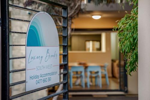 a sign for aeway drug store with a table at Surfside 4 in Yallingup