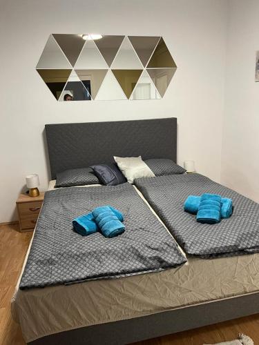 a large bed with two blue pillows on it at Apartman Lara in Zagreb