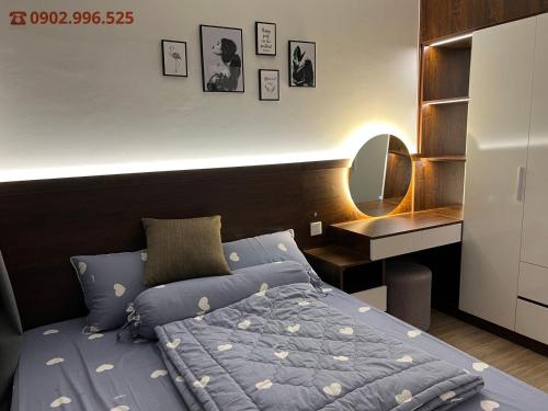 um quarto com uma cama e uma secretária com um espelho em Luxury Apartment-Vinhomes Grand Park Quận 9-Bống Homestay em Long Bình