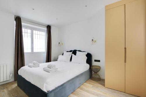 une chambre avec un grand lit avec deux animaux en peluche dessus dans l'établissement Pick A Flat's Apartment in Montorgueil - Rue Notre Dame de Recouvrance, à Paris