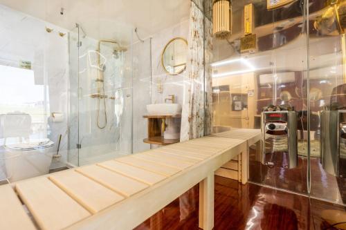 a bathroom with a shower and a long wooden bench at Marina Martinshafen in Sassnitz