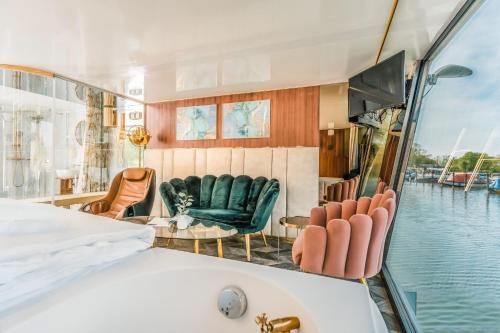 a room with chairs and a couch on a boat at Marina Martinshafen in Sassnitz