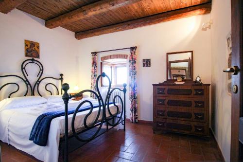 a bedroom with a bed and a dresser and a mirror at Santo'S House BnB in Santo Stefano di Sessanio